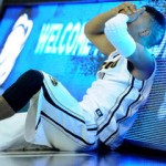 Mizzou player slumped near scoreboard after an embarrassing loss.